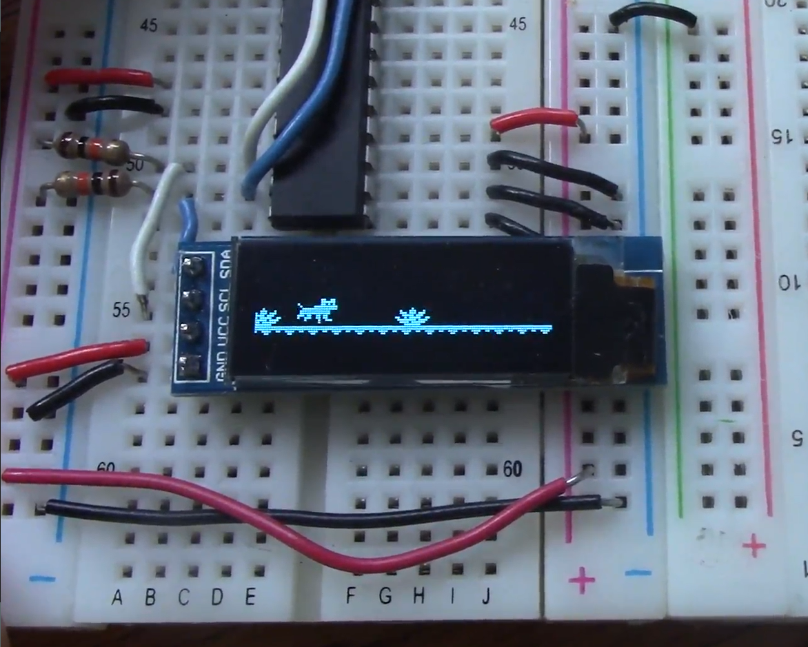 a screen on a breadboard displaying a running dog