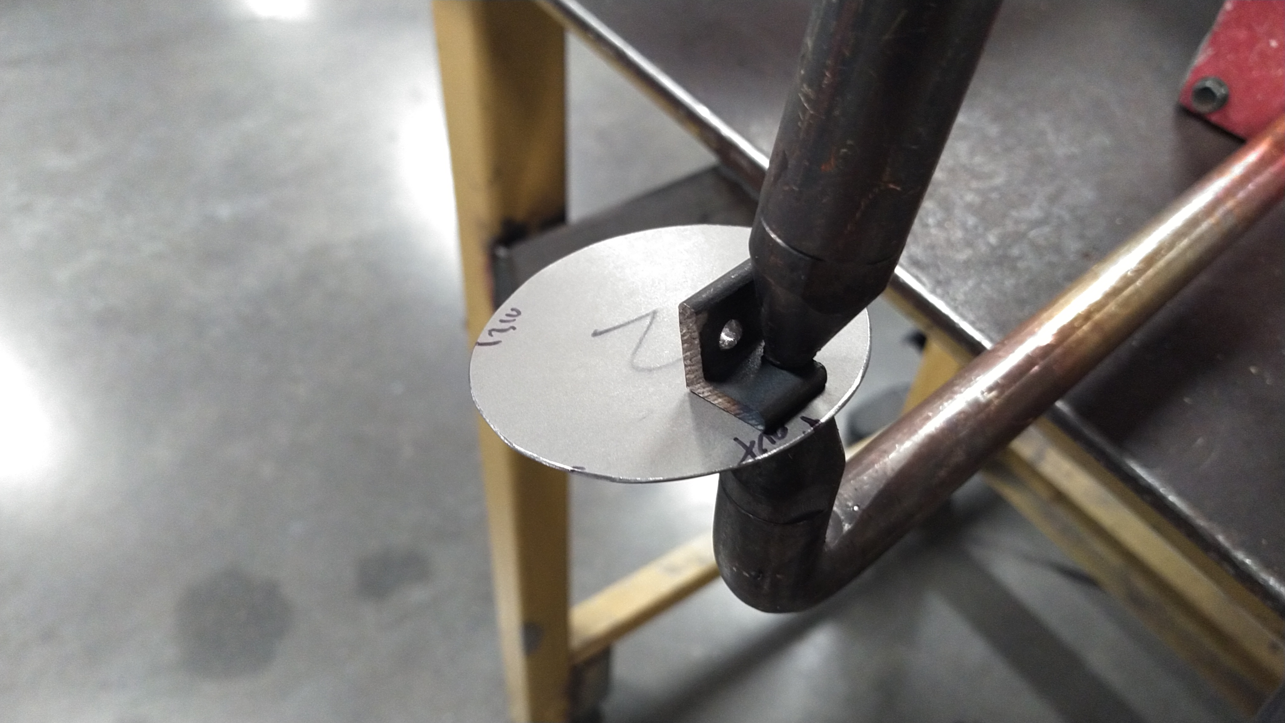 A bracket being spot welded to a piece of sheet metal