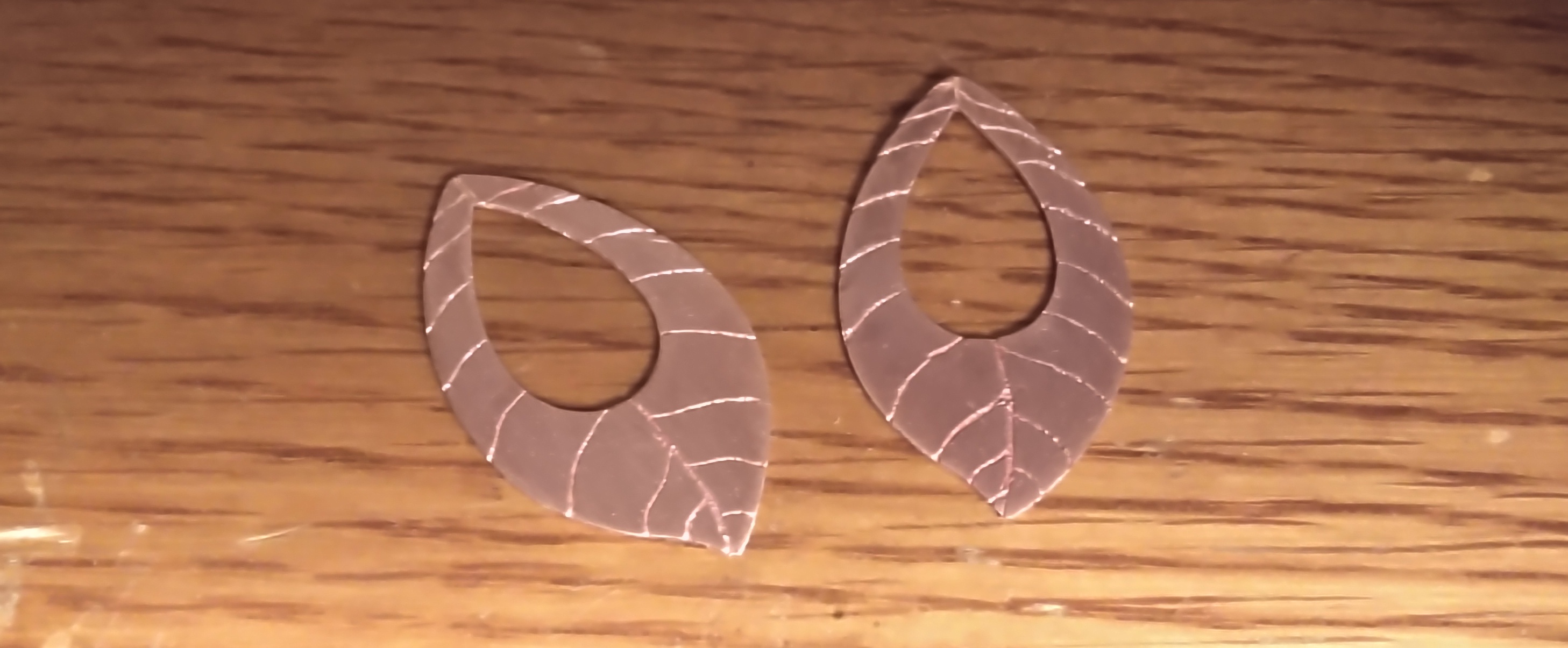 Two engraved pieces of copper made to look like walnut leaves