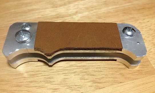 an aluminum knife handle with leather scales