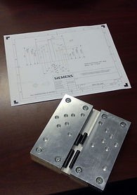 an aluminum block with holes and a groove to fit a miter gauge