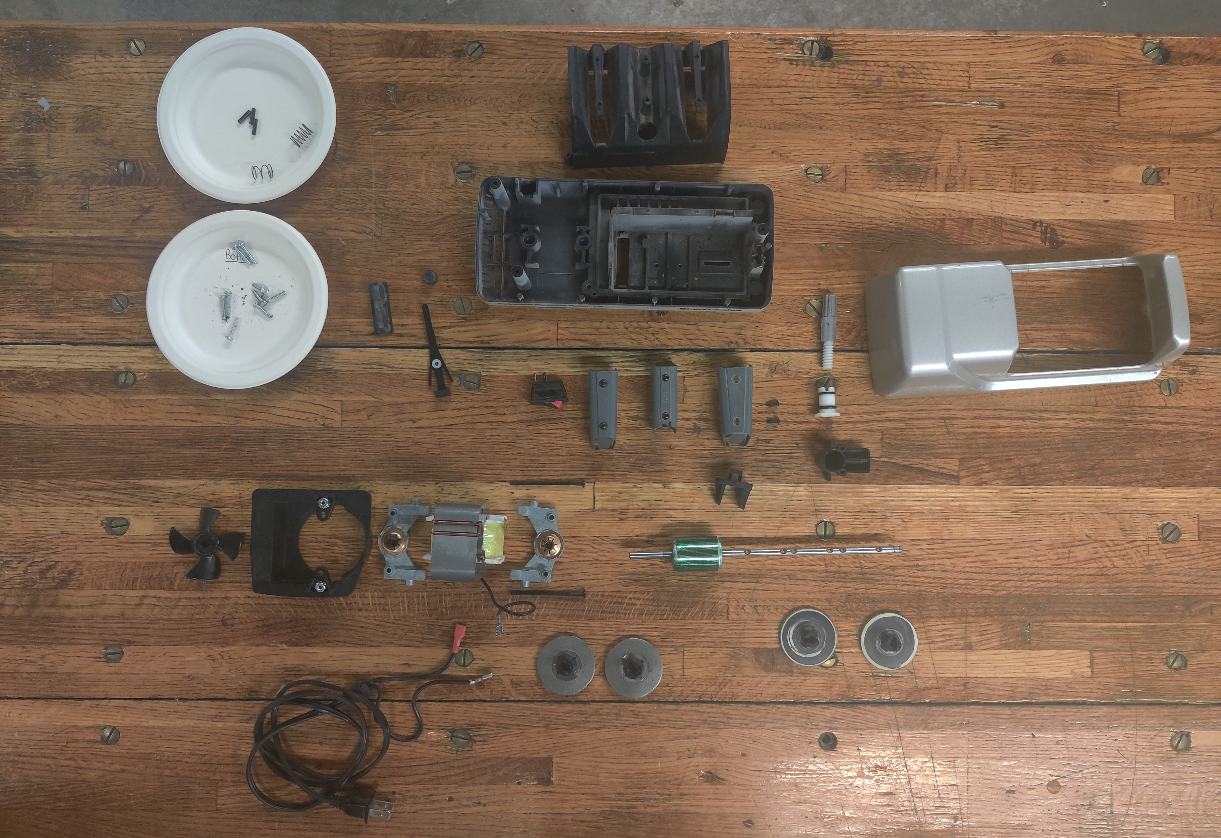 the components of a knife sharpener laid out on a table