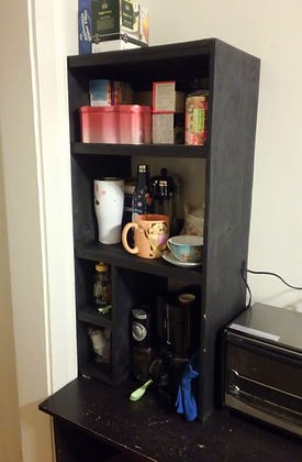 a black shelf full of coffee and tea supplies