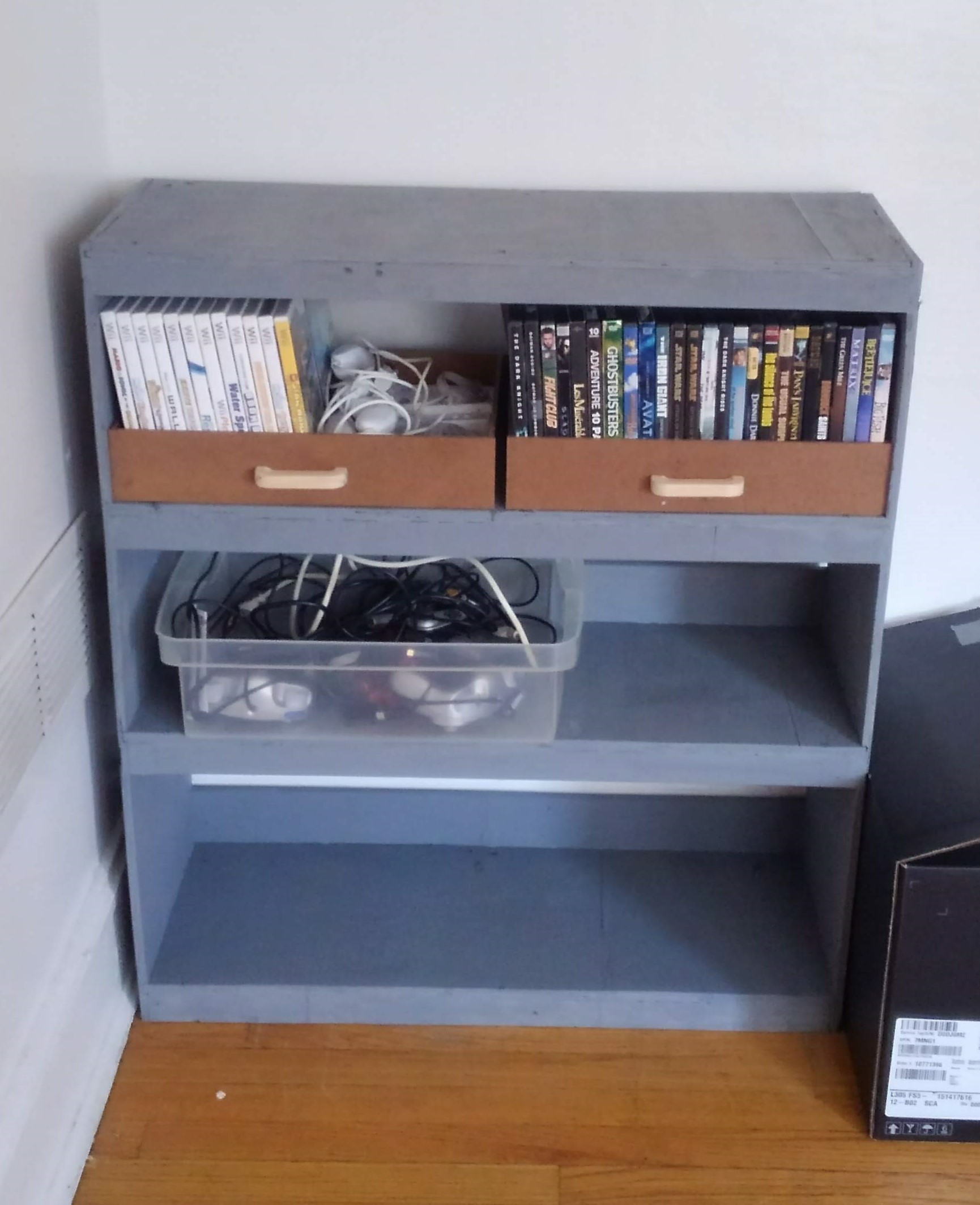 a gray shelf containing entertainment equipment