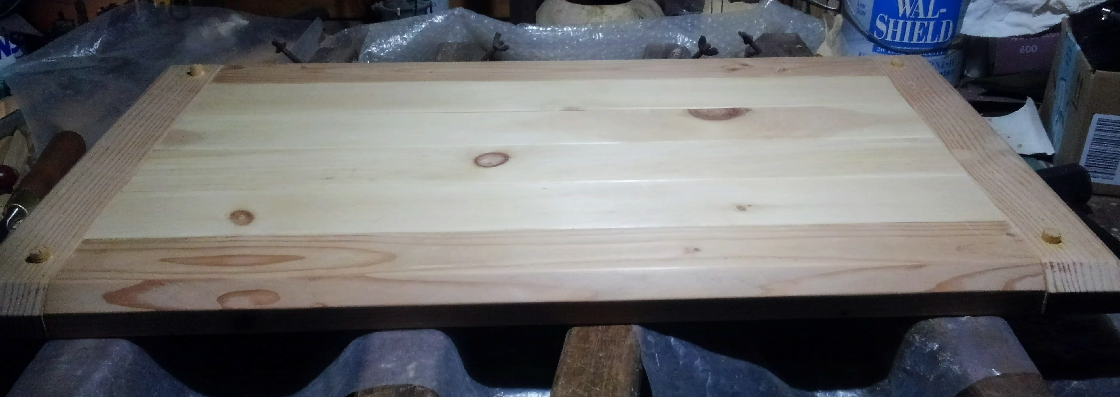 a chest lid with pegs driven into it