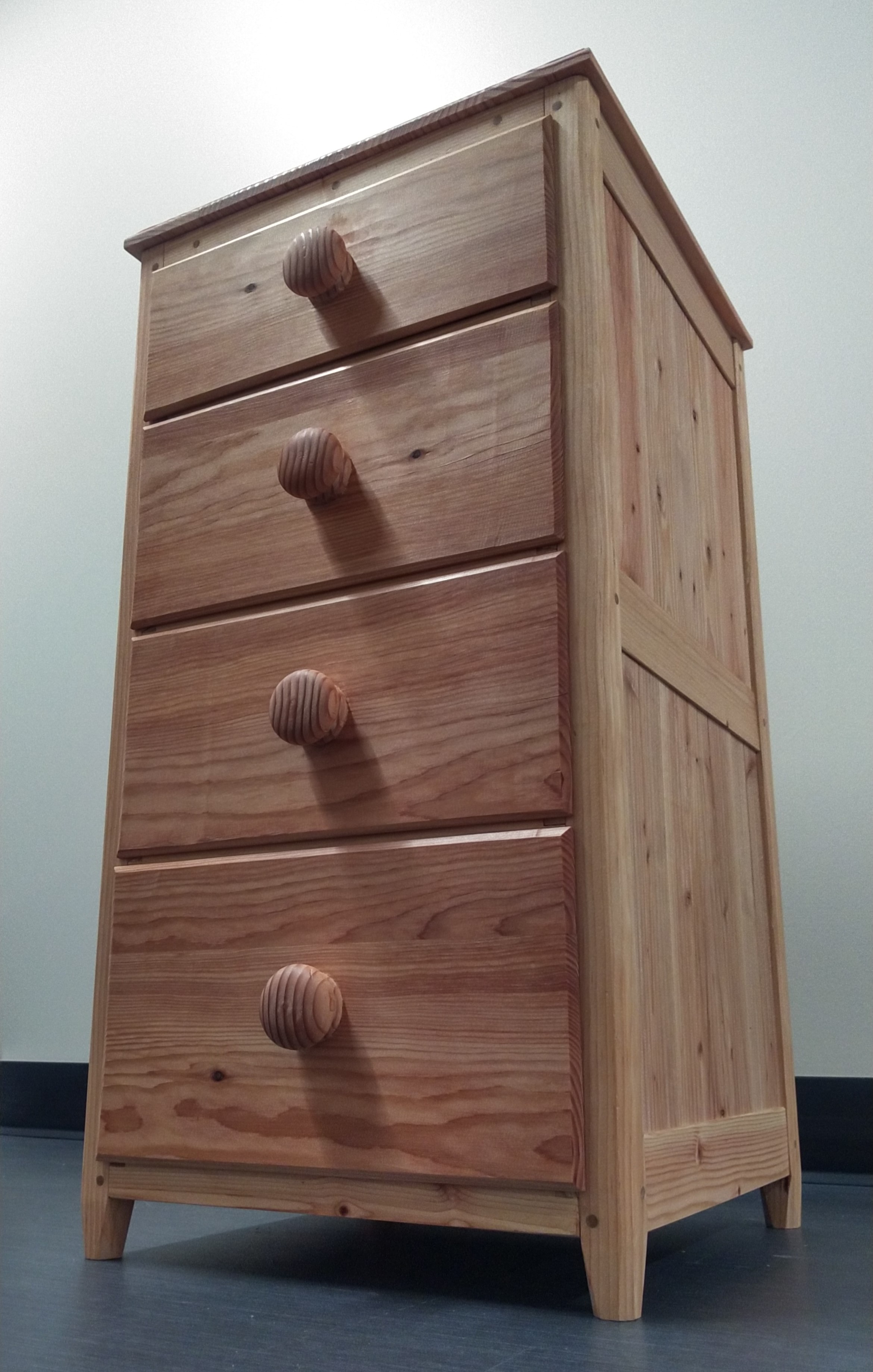 a nightstand with four drawers seen from below