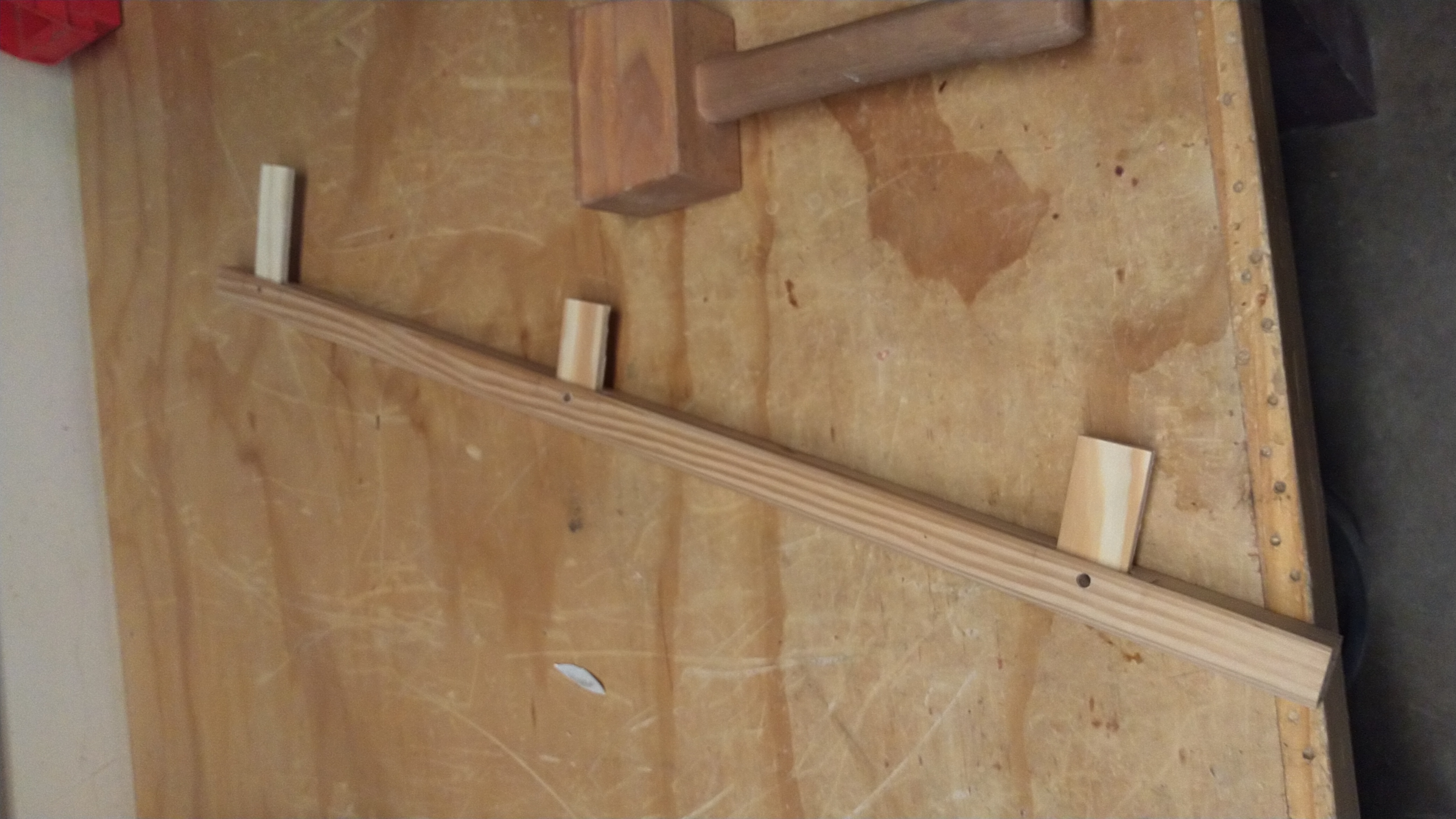 Holes drilled into a piece of wood with mortises