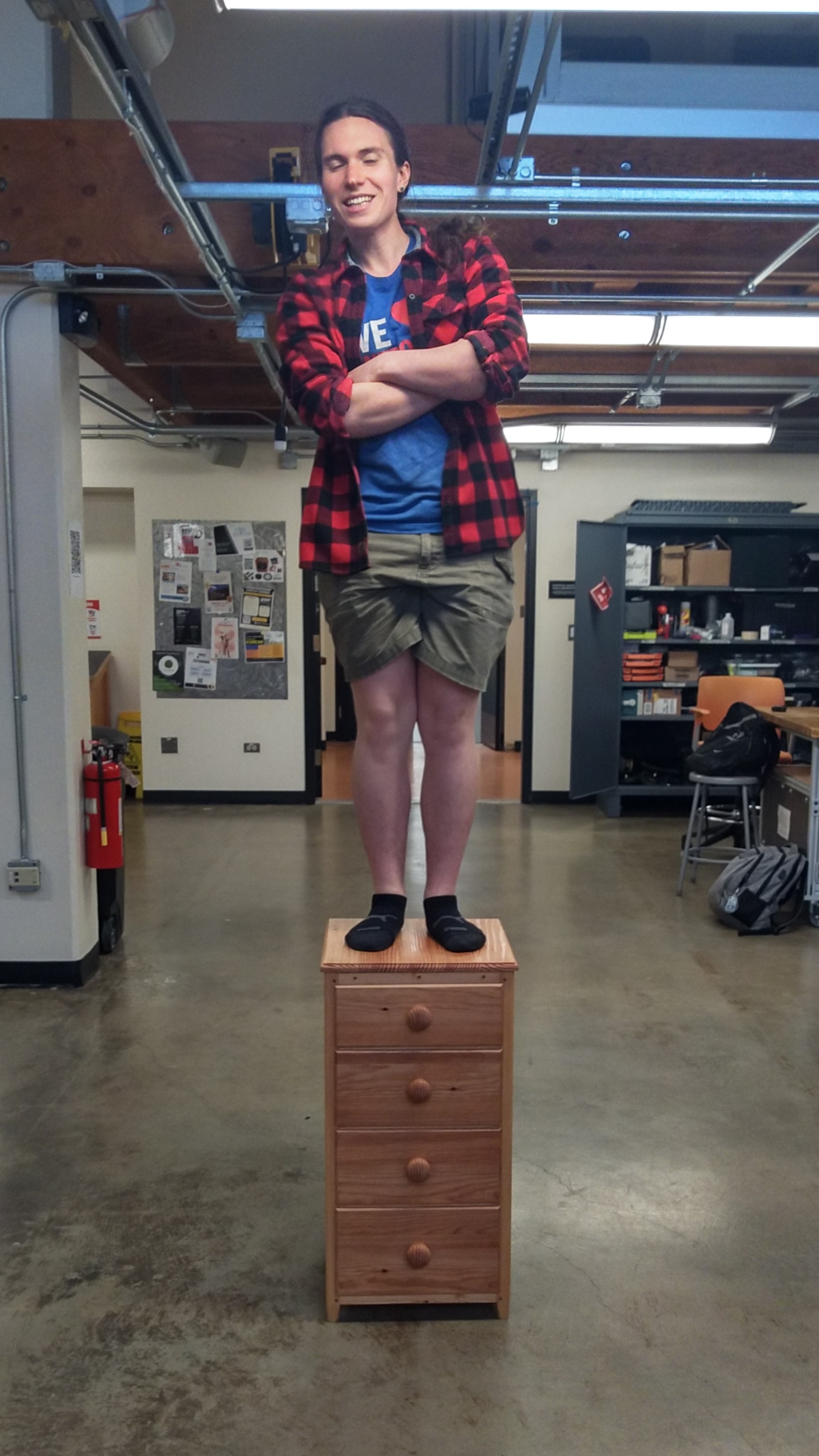 A person standing on top of a nightstand