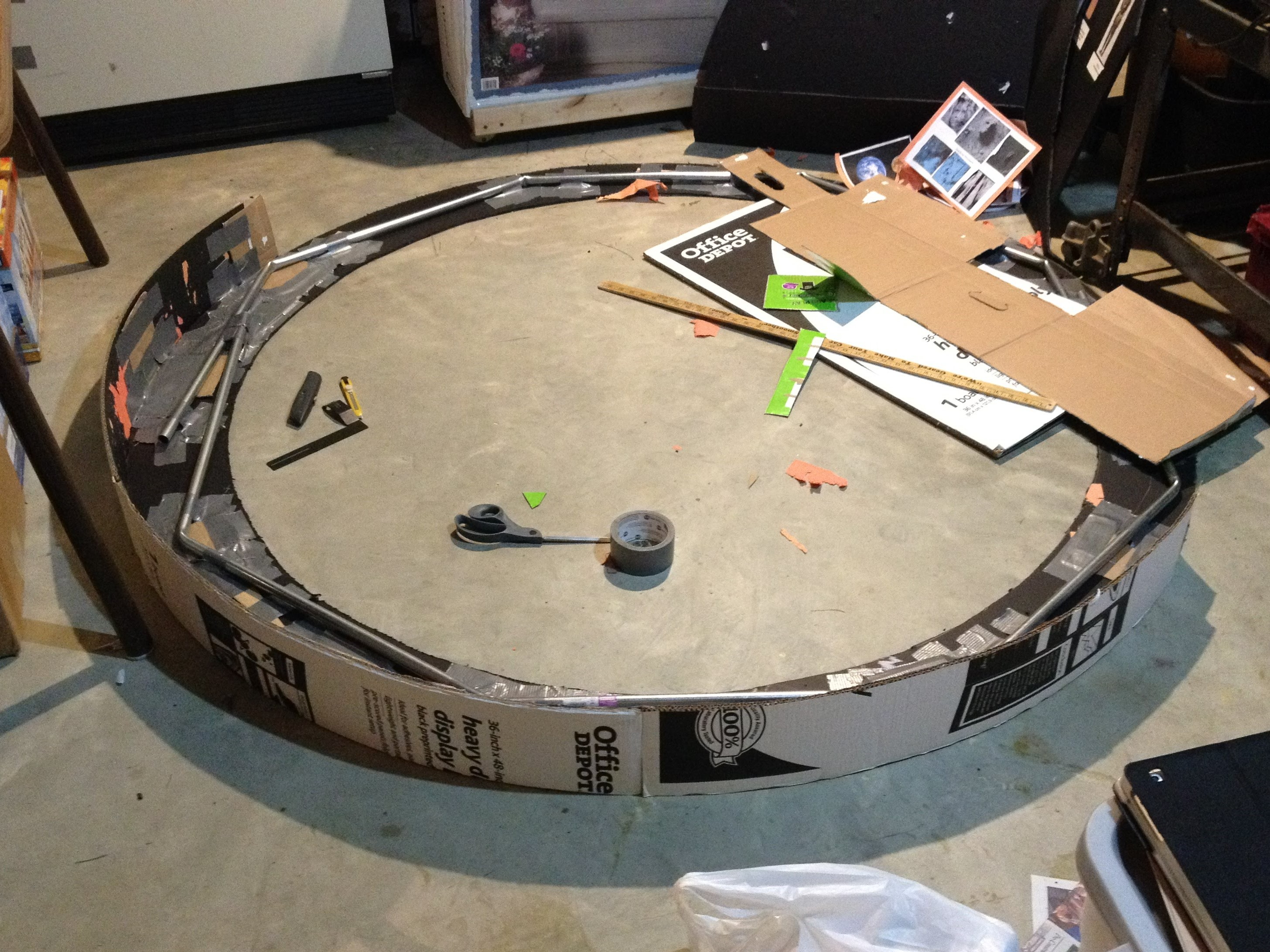 cardboard and foamboard being formed around an octagonal metal frame.