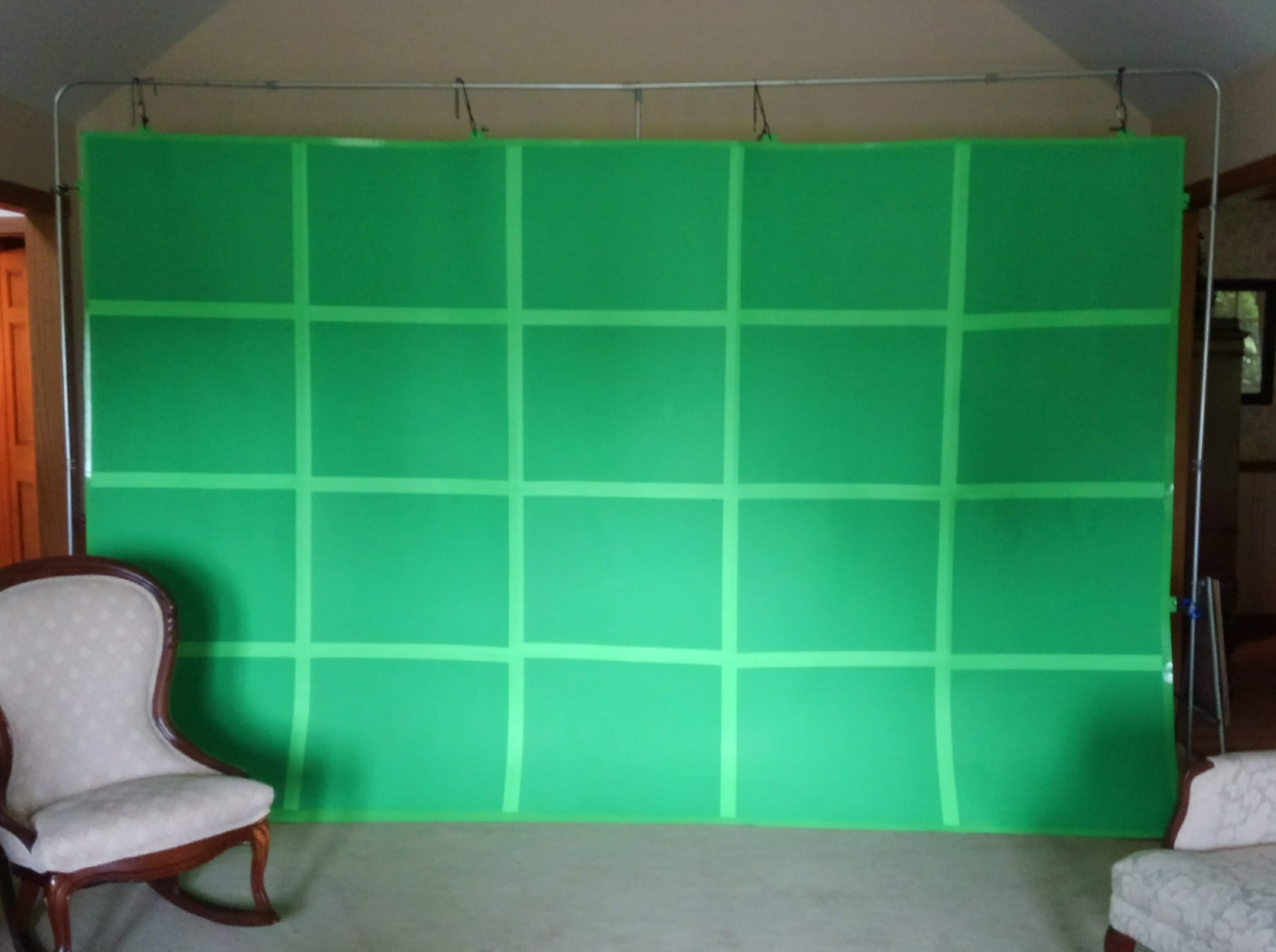 a green screen suspended from a self-standing frame