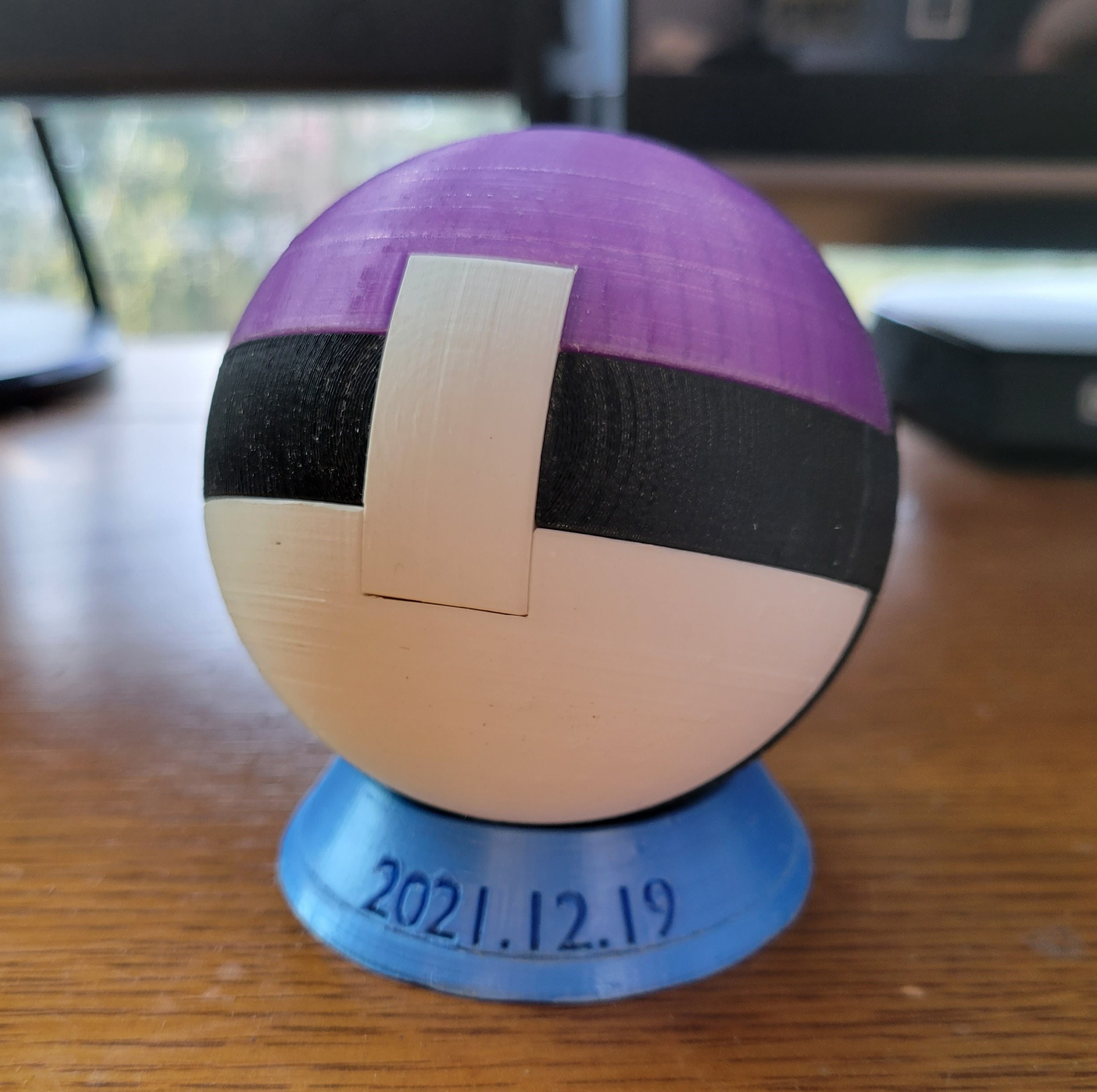 a 3D printed puzzle sphere on a stand