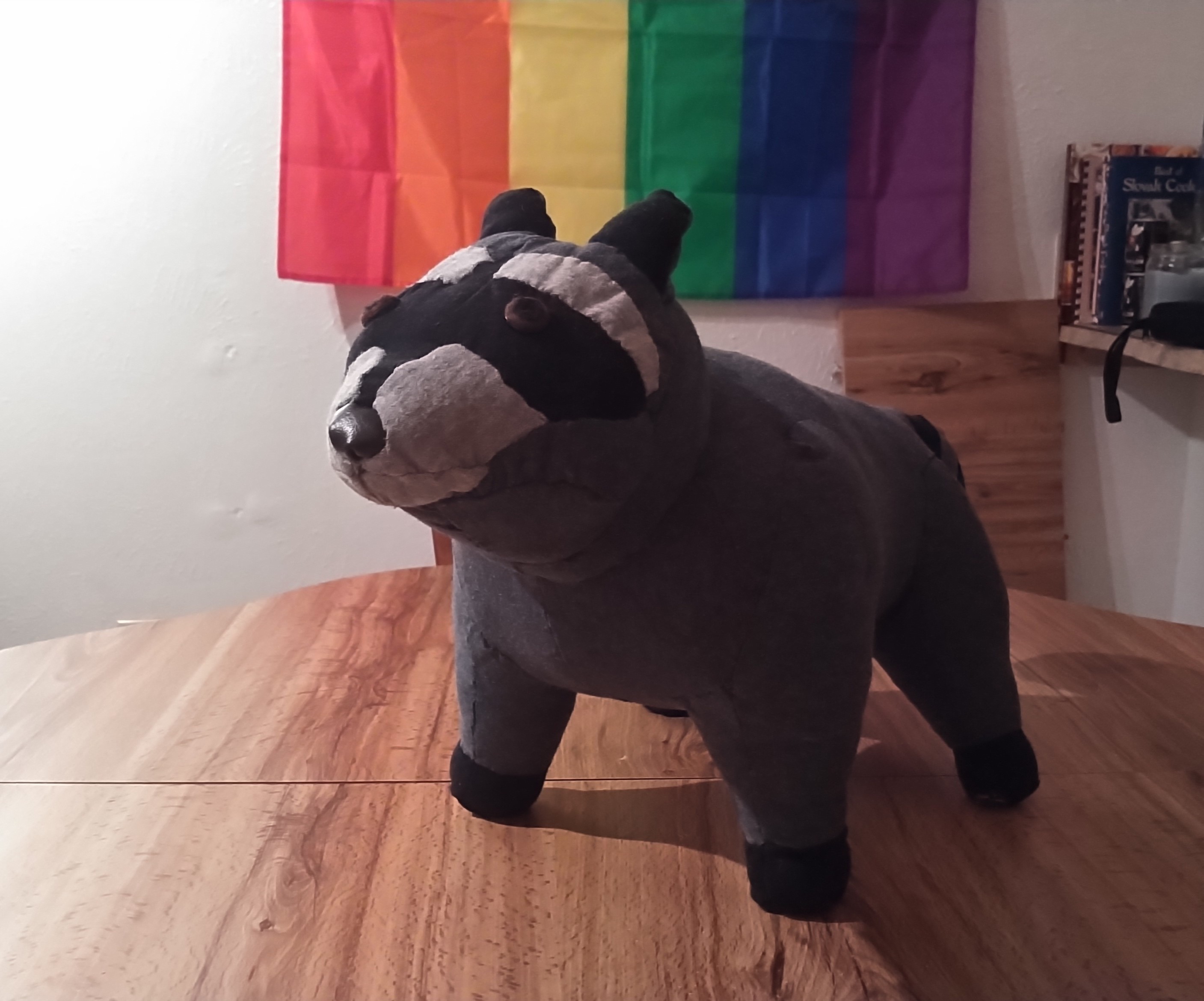 a very strong-looking stuffed racoon made from t-shirt fabric