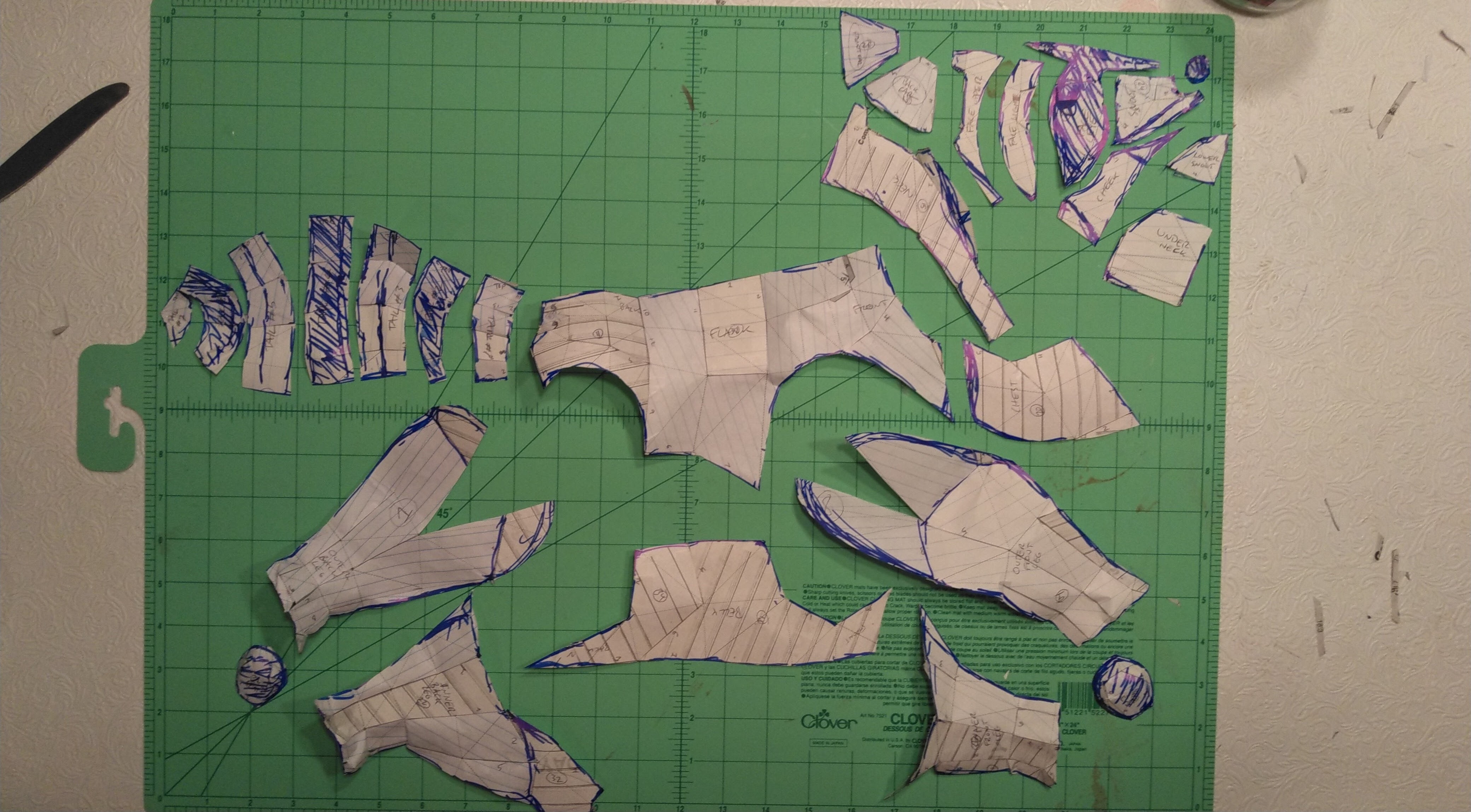 A paper model of a strong racoon cut into roughly flat pieces