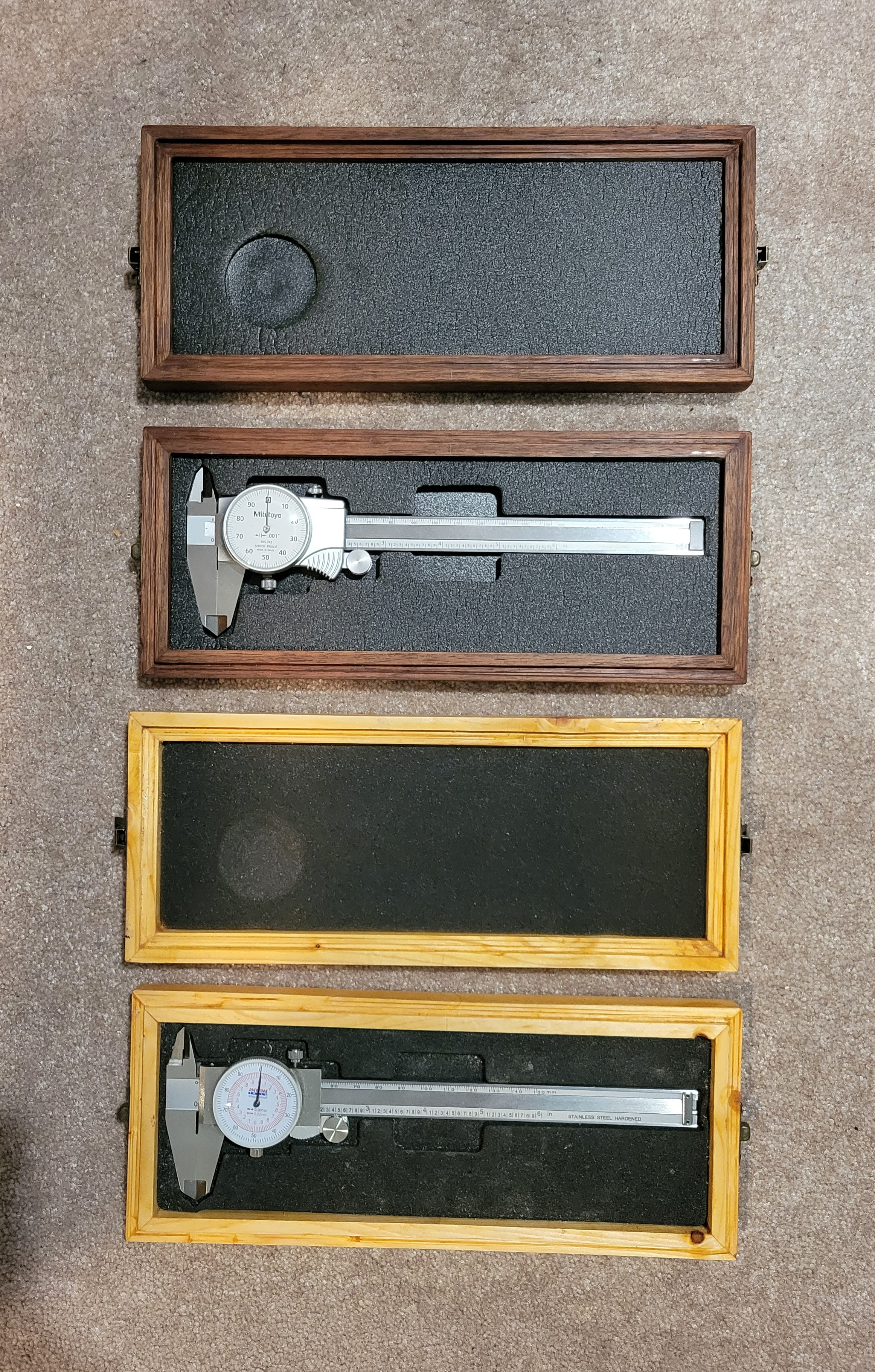 two pairs of calipers, each in a box
