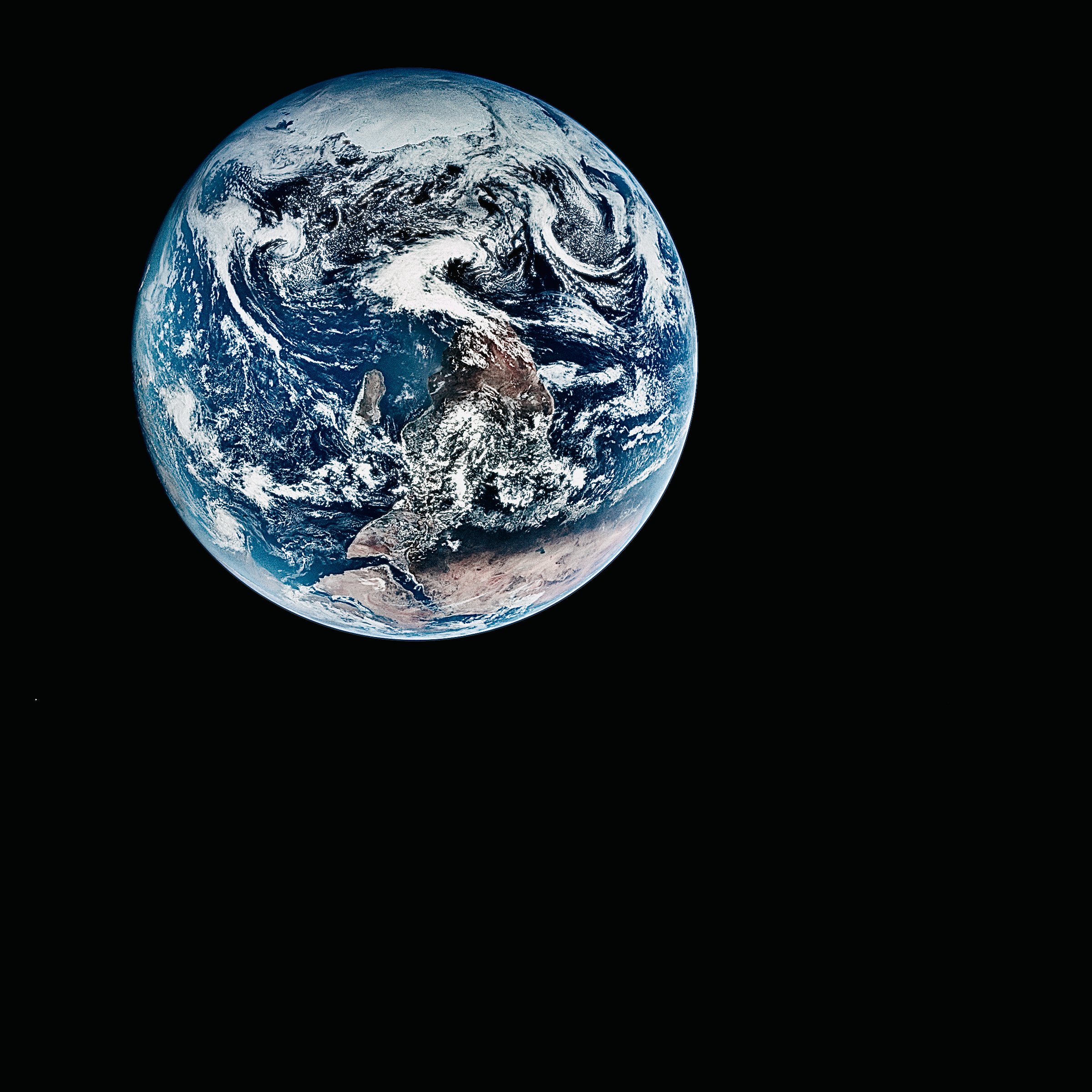 A picture of planet earth taken from space, south-side up. Earth is in the corner of the frame